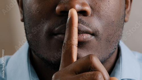 Quadro su tela Mysterious unknown male face part african american adult man put finger to lips