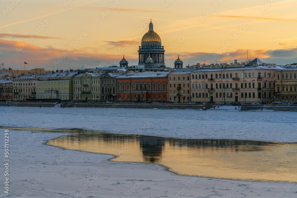 View of the English embankment of the Neva and St. Isaac's Cathedral against the background of the dawn sky on a winter morning, St. Petersburg, Russia