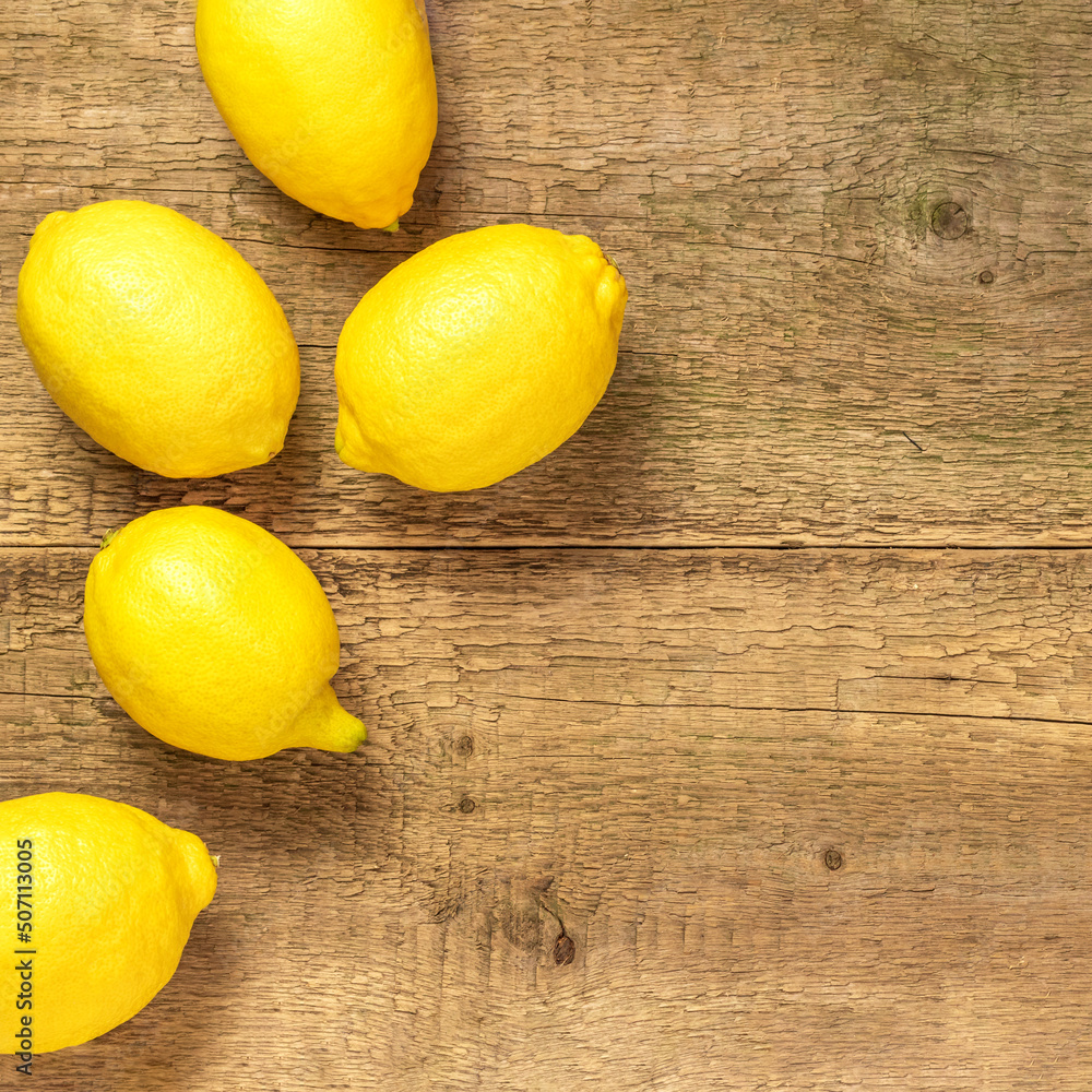 Fresh lemons on a wooden table.Copy space for text. Top view.