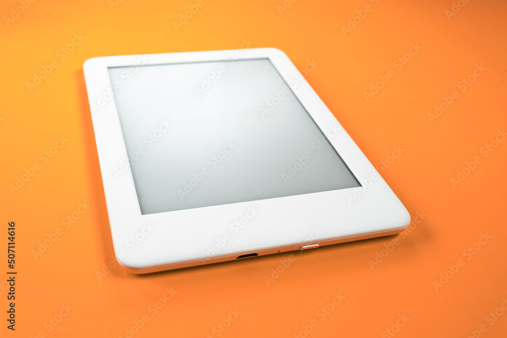 Ebook reader over yellow background Ebook reader over yellow background