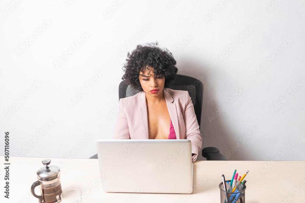 young mexican latin woman working on laptop in office young mexican latin woman working on laptop in office