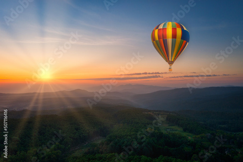 Aerial view of sunrise with ballon over mountian and pine tree in Chiang Mai Province, Thailand © nuttawutnuy