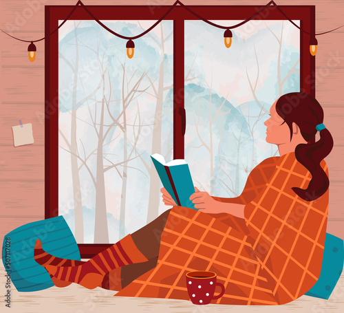 A girl in a plaid, with book in her hands, is sitting on the windowsill and looking out the window. Outside the window is a winter landscape. Cozy winter. Vector illustration in flat style