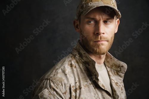 White military man wearing uniform posing and looking aside