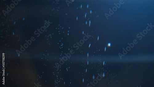 Slow motion air bubbles in water rising up to the surface . Slowmotion air bubbles floating under transparent water bubbles in aquarium photo