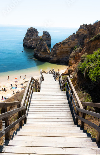 stairs of the praia do camilo a beautiful beach surrounded by cliffs in lagos portugal photo