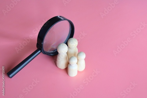Tableau sur toile Wooden dolls and magnifying glass