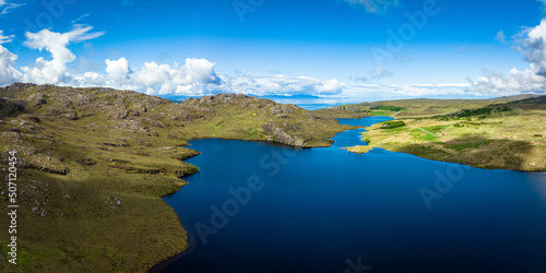 Aerial view of the landscape surrounding Diabaig, Lower Diabaig and Torridon village in the north west highlands of Scotland during summer on a blue sky day with light clouds