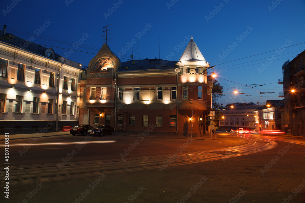 Fototapeta premium Moscow, Russia - July, 27 2014: Historical buildings in Moscow center at night. Mansion on Yauza boulevard. Tram rails and light traces on foreground.
