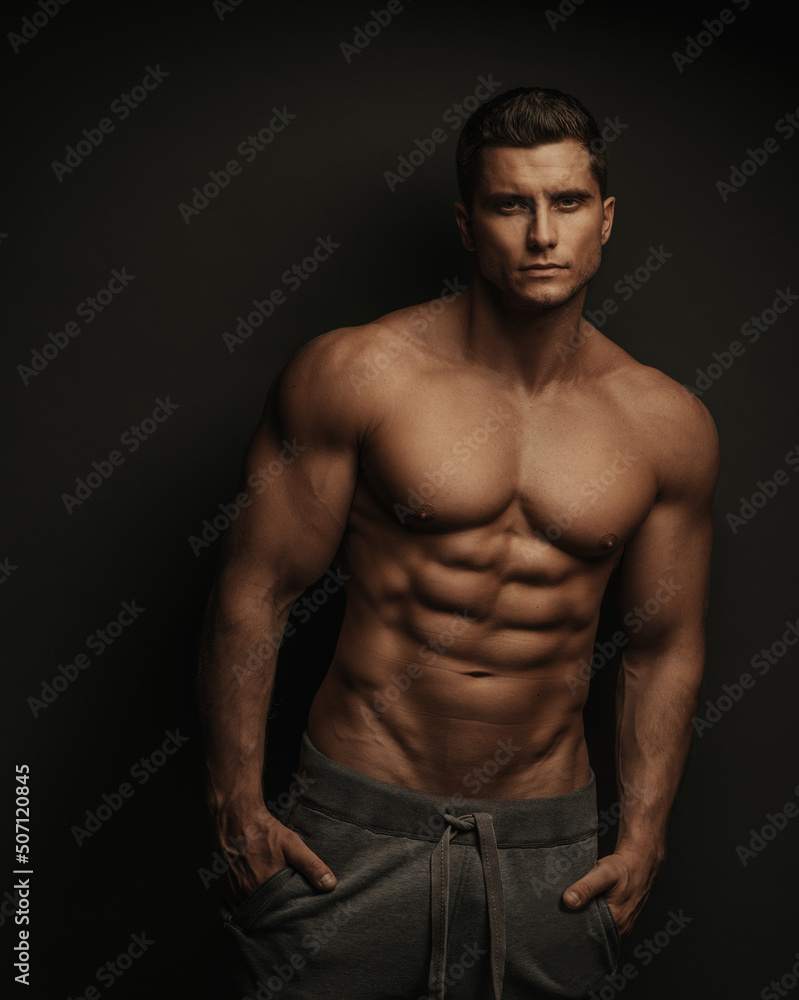 Fototapeta premium Shirtless sexy muscled male model standing in studio