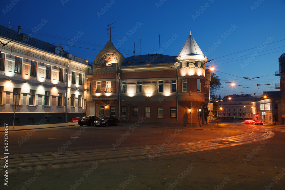 Fototapeta premium Moscow, Russia - July, 27 2014: Historical buildings in Moscow center at night. Mansion on Yauza boulevard. Tram rails and light traces on foreground.