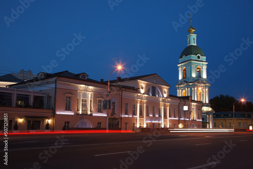 Moscow, Russia - July, 27 2014: Historical center at night. Mansion (left) and church bell tower (right).
