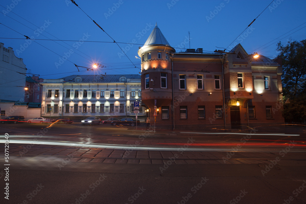 Fototapeta premium Moscow, Russia - July, 27 2014: Historical buildings in Moscow center at night. Mansion on Yauza boulevard. Tram rails and light traces on foreground.