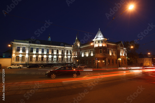 Moscow, Russia - July, 27 2014: Historical buildings in Moscow night downtown. Mansion on Yauza boulevard. Tram rails and light traces on foreground.