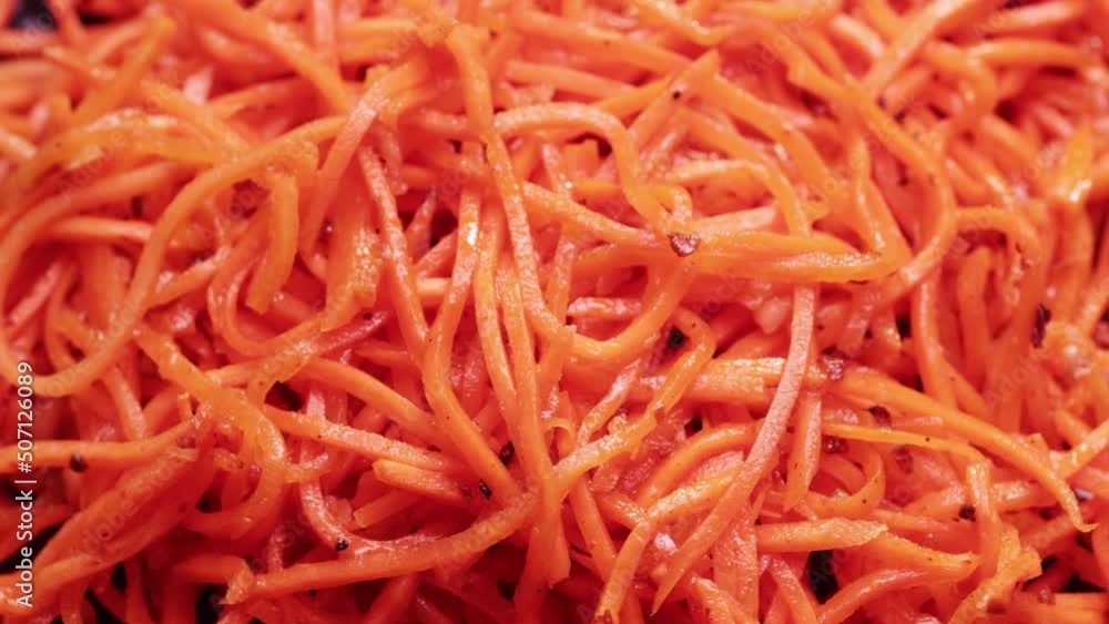 Bulk heap of Korean salad of chopped carrots, garlic, vegetable oil Bulk heap of Korean salad of chopped carrots, garlic, vegetable oil