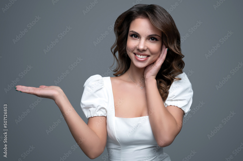 Beautiful female model presenting your product holding on her palm Beautiful female model presenting your product holding on her palm