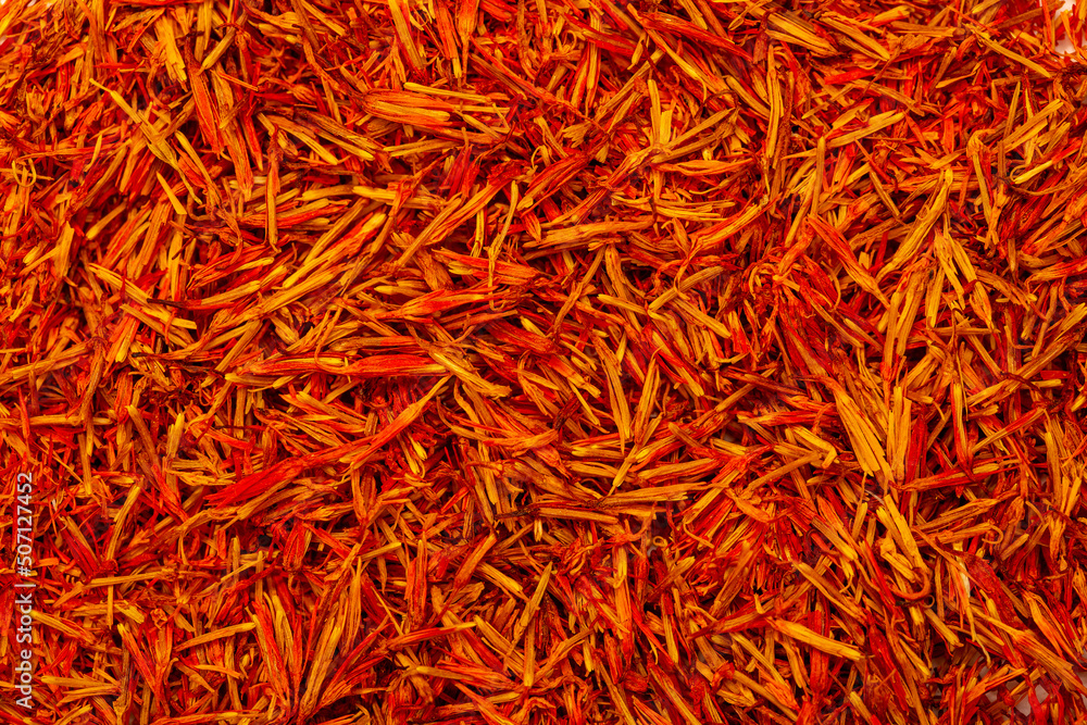 Saffron spice, pistils and stigmas of a crocus flower close-up, flat lay as a background. Indian and Arabic spices for cooking. Medicinal herbs and spices. Saffron spice, pistils and stigmas of a crocus flower close-up, flat lay as a background. Indian and Arabic spices for cooking. Medicinal herbs and spices.