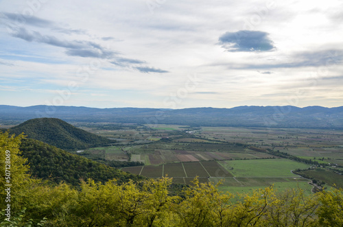 Panoramic view of Alazani valley fields and Caucasus Mountains from the height of the hill, Kakheti region, Georgia 
