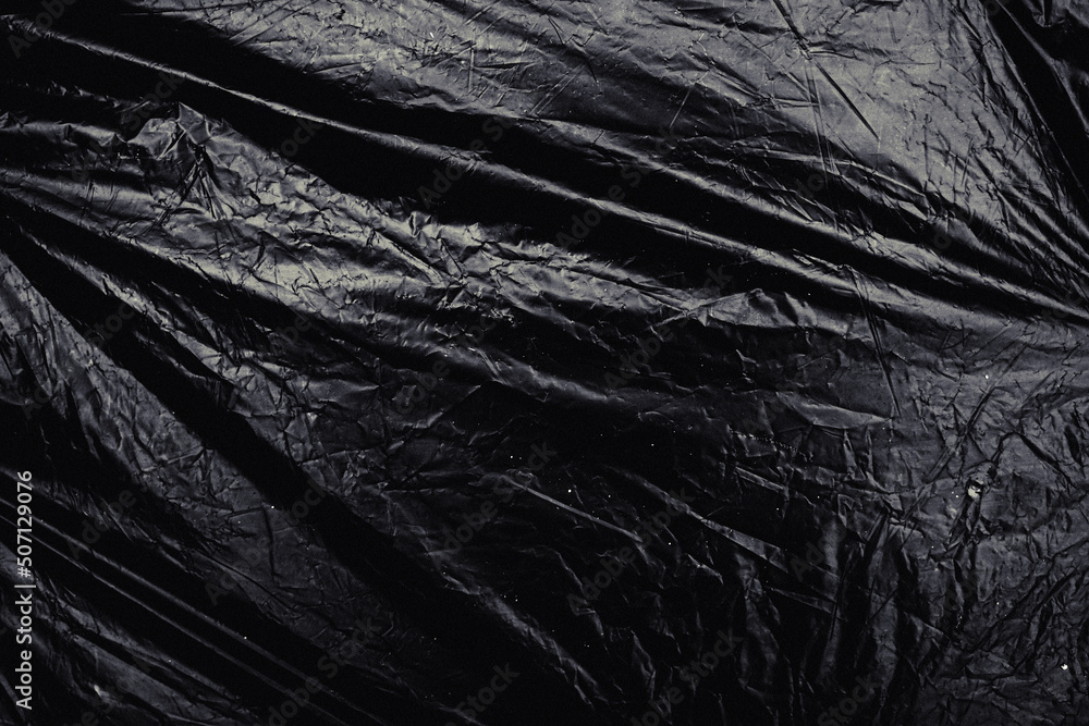 a transparent stretch plastic wrap on black background. realistic plastic wrap texture for overlay and effect. wrinkled plastic pattern for creative and decorative design. a transparent stretch plastic wrap on black background. realistic plastic wrap texture for overlay and effect. wrinkled plastic pattern for creative and decorative design.