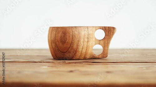 Empty wooden cup on a wooden table background