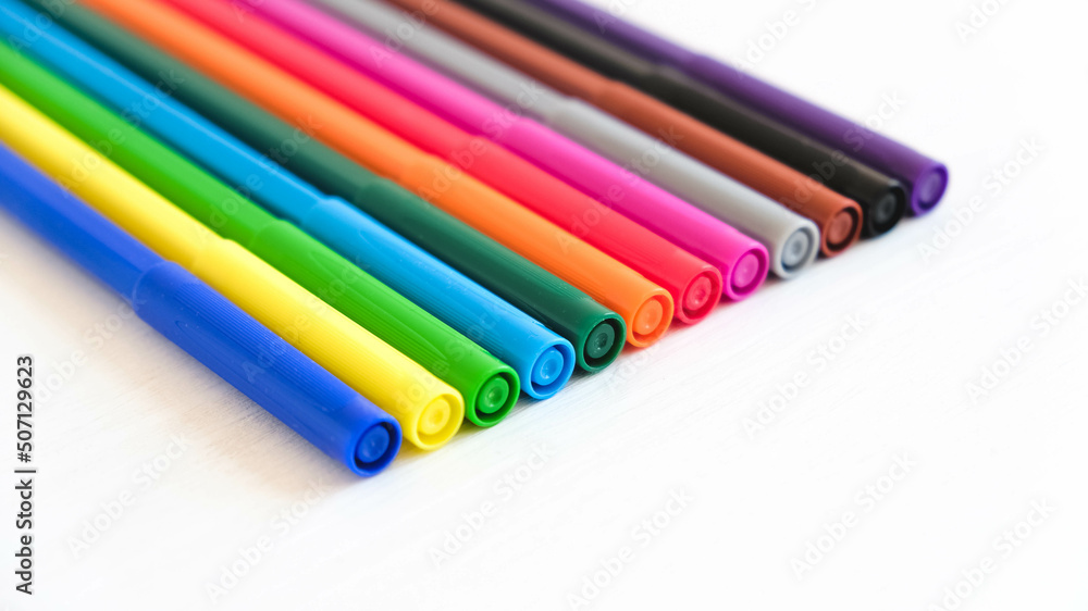 Multicolored felt-tip pens on a white background Multicolored felt-tip pens on a white background