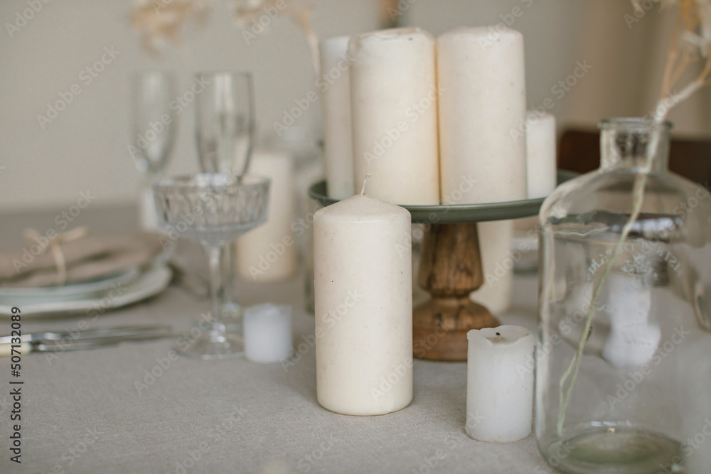 Close up of stylish table setting in beige colors. Natural materials, home decorations. Aesthetics. Close up of stylish table setting in beige colors. Natural materials, home decorations. Aesthetics.