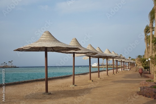 Row of umbrellas, on Arabia Azur beach resort, in Hurghada, Egypt.