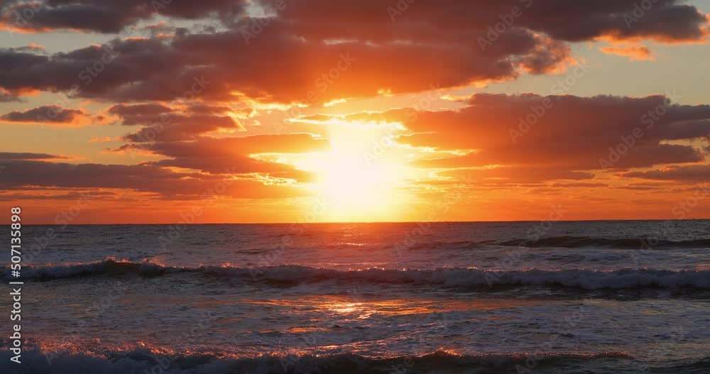 Golden ocean waves. Dramatic sunrise view of waving sea, sand and beach Golden ocean waves. Dramatic sunrise view of waving sea, sand and beach