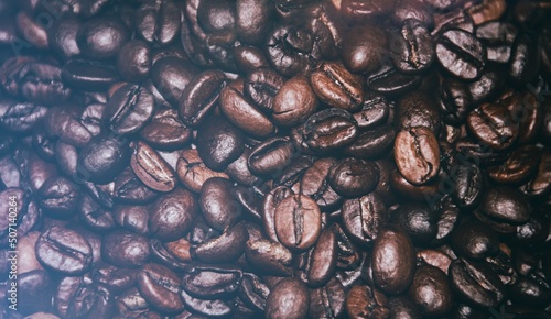 Background of roasted coffee beans close-up view from above. Coffee beans close-up. 