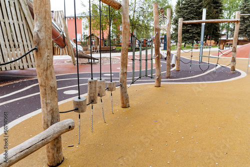The children's sports complex is made of logs, a wooden playground in the city park, obstacles for children, the development of dexterity and coordination, safe playground coverage.
