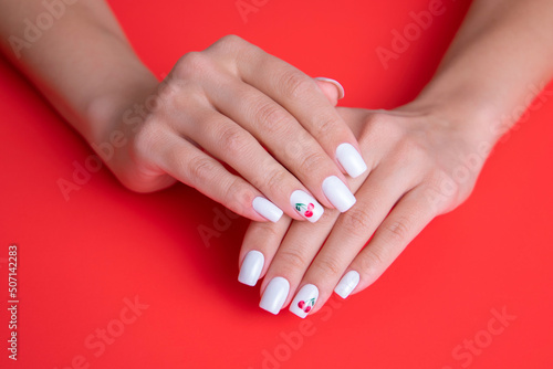 Beautiful female hands with white manicure nails 