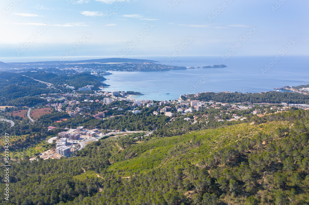 Aerial view of Peguera from mountain side with hotels and beaches. Sea in background. Mallorca, Balearic Islands, Spain
