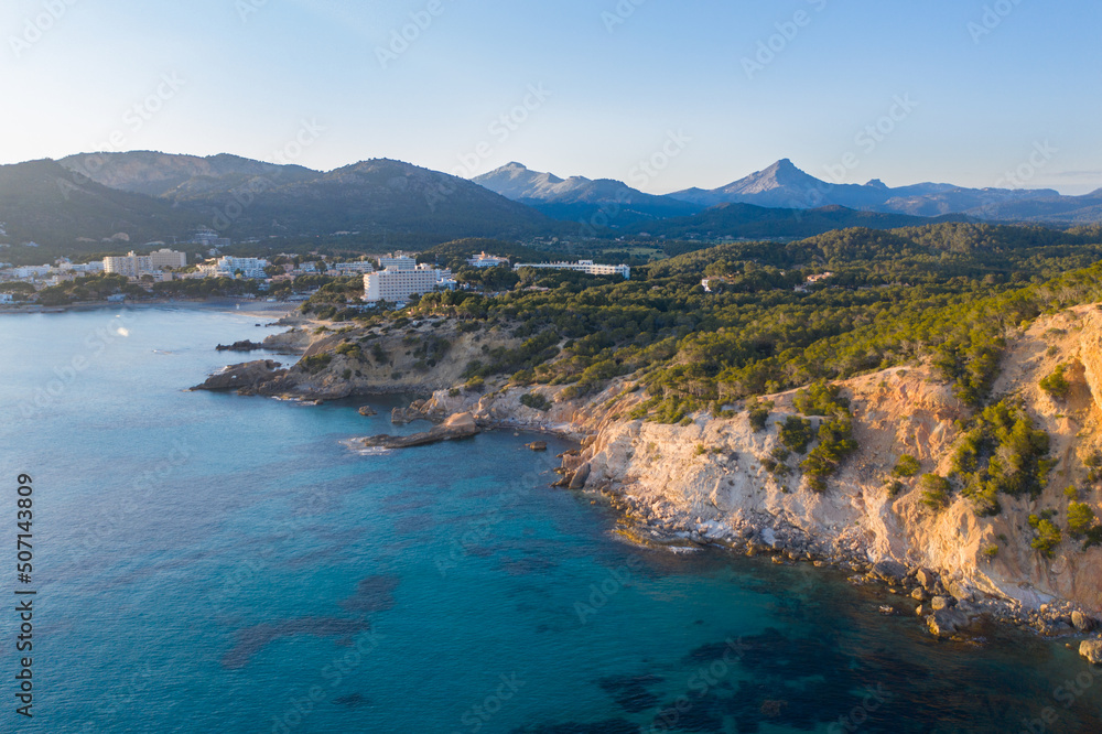 Aerial view of Peguera from sea side with hotels and beaches. Mountains in background. Mallorca, Balearic Islands, Spain