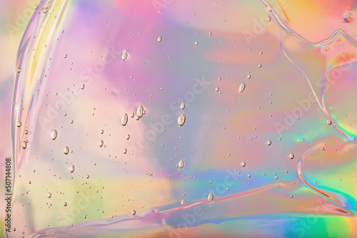Abstract cosmetics gel on holographic background.Good as cosmetic banner.