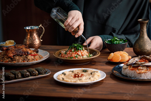 Kabsa, hummus, maqluba, maqluba, tabbouleh close-up, rice and meat dish, middle eastern national traditional food. Muslim family dinner, Ramadan, iftar. Arabian cuisine. © Eleven studio