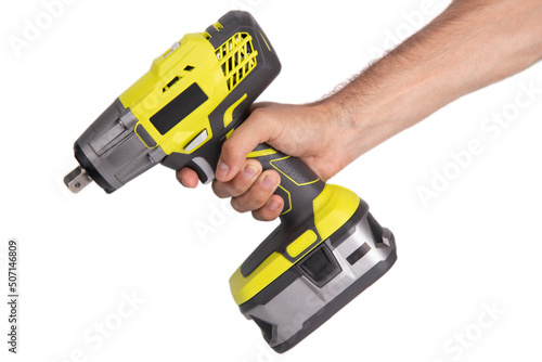Hand holding yellow battery wrench on white background