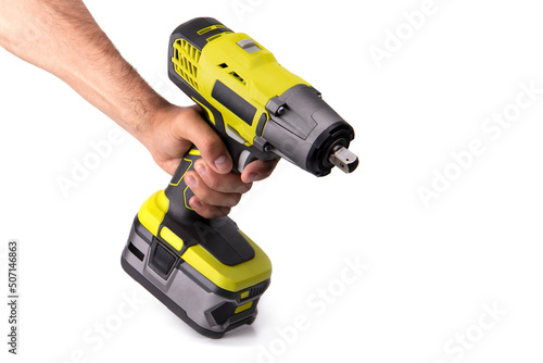 Hand holding yellow battery wrench on white background