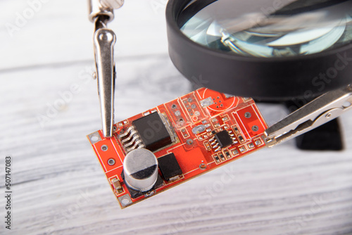 Chip with a magnifying glass on a light background