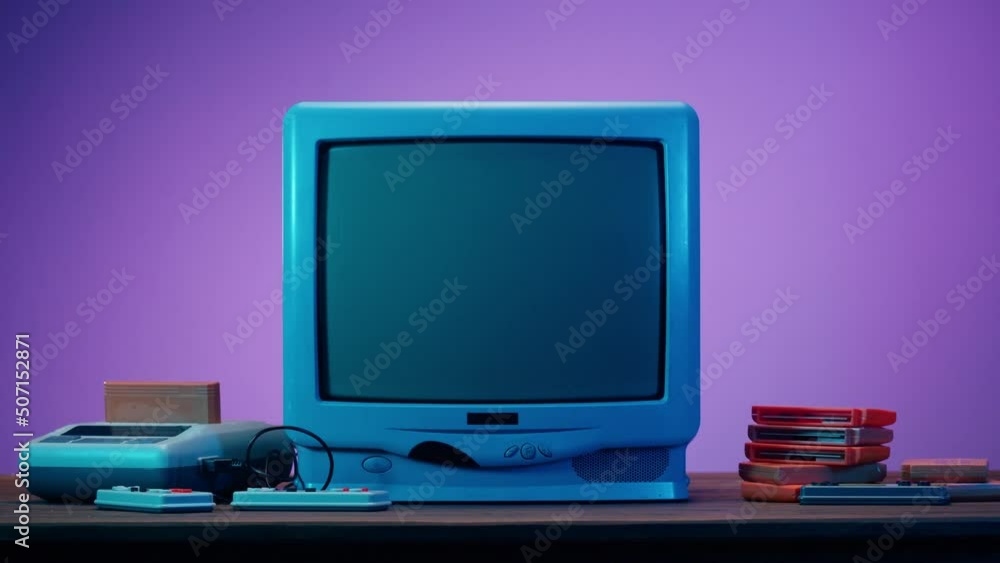 Old television with grey screen on purple neon background. Closeup of