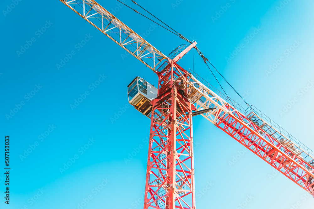 Construction crane against the blue sky. Construction of a new building. The concept of building a new area. Construction crane against the blue sky. Construction of a new building. The concept of building a new area.