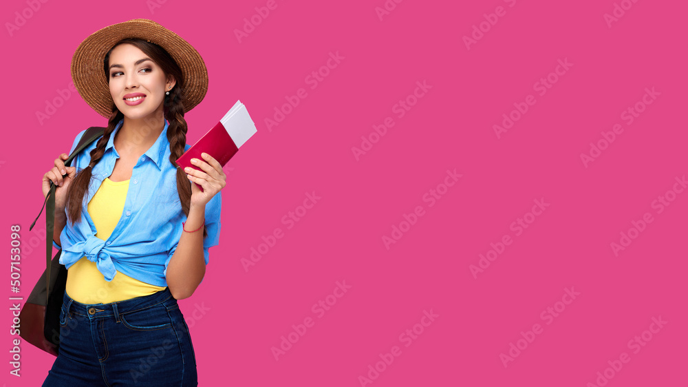 Traveler tourist woman holding flight ticket and passport on isolated pink background. Studio shot. Concept of tourism Traveler tourist woman holding flight ticket and passport on isolated pink background. Studio shot. Concept of tourism
