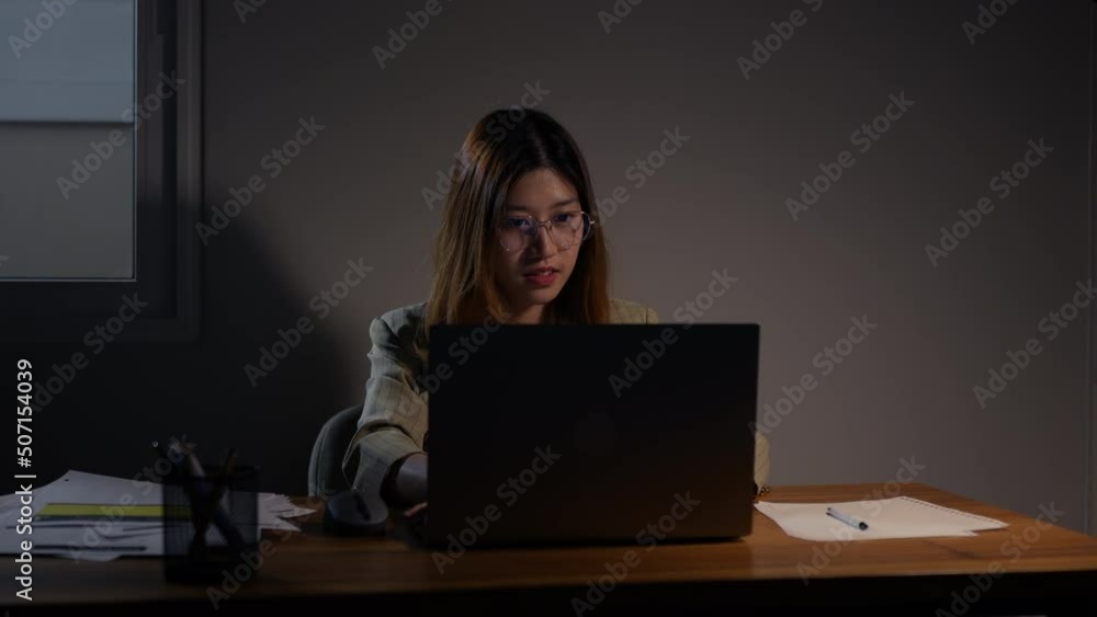 woman working late time at night typing keyboard laptop computer home office workhard overworked, Freelancer stay home business quarantine sleepless crisis coronavirus stay home dark room. woman working late time at night typing keyboard laptop computer home office workhard overworked, Freelancer stay home business quarantine sleepless crisis coronavirus stay home dark room.
