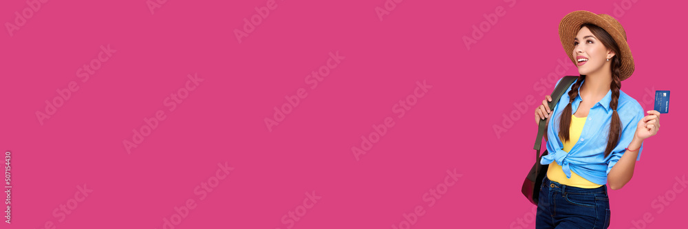Smiling caucasian woman holding credit card isolated on pink background. Online shopping, e-commerce, internet banking, spending money, enjoying life concepts Smiling caucasian woman holding credit card isolated on pink background. Online shopping, e-commerce, internet banking, spending money, enjoying life concepts