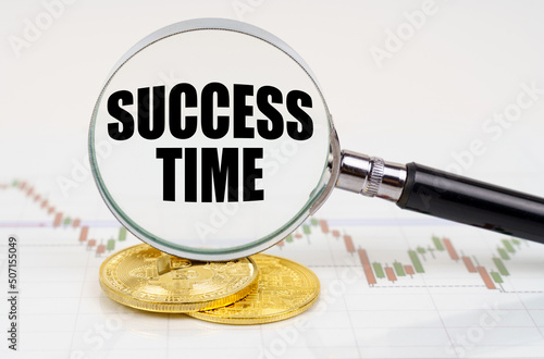 On the chart with quotes are bitcoins and there is a magnifying glass with the inscription - Success time photo