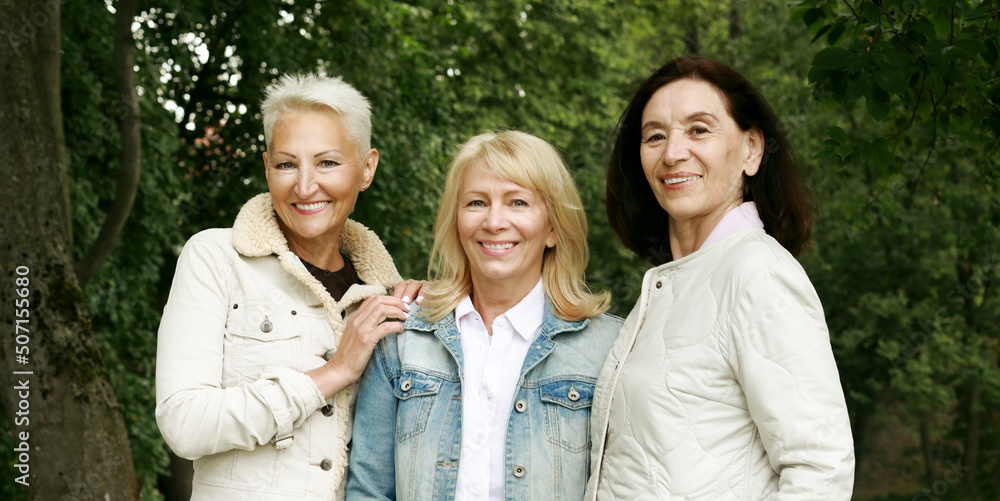 Three women friends in the park. Sixty-year-old ladies are dressed in casual clothes. Summer time. Three women friends in the park. Sixty-year-old ladies are dressed in casual clothes. Summer time.
