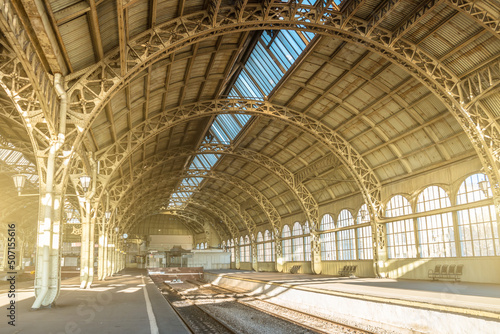 Architecture curved arches, metal struts and glass roof, interior details at empty train station © aapsky