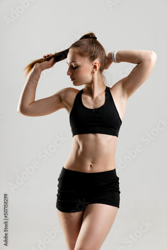 Athletic girl with embossed abs in black sportswear © Mkorobsky