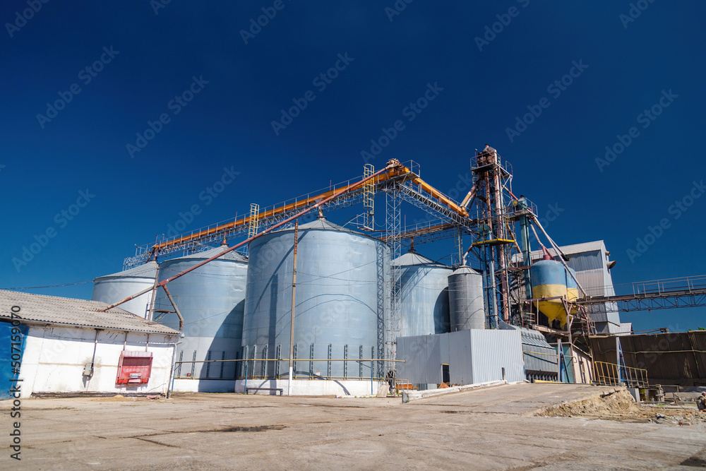 Grain elevator in Ukraine. Russia blocking shipping of wheat, seeds and corn harvest export. World crisis, starvation. Blockade of Ukrainian crops supplies Grain elevator in Ukraine. Russia blocking shipping of wheat, seeds and corn harvest export. World crisis, starvation. Blockade of Ukrainian crops supplies