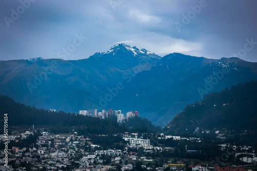 View of a district in Pichincha with snowy mountain in the background in the late afternoon. © SMaggi
