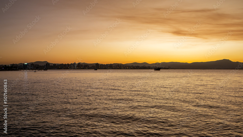 Sunset view in Florianopolis in southern Brazil. Boardwalk by the sea. Panorama. Nature. Cityscape. Golden hour.